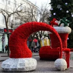 giant christmas boot and santa hat motif lights turned off outdoor holiday decoration display in city square