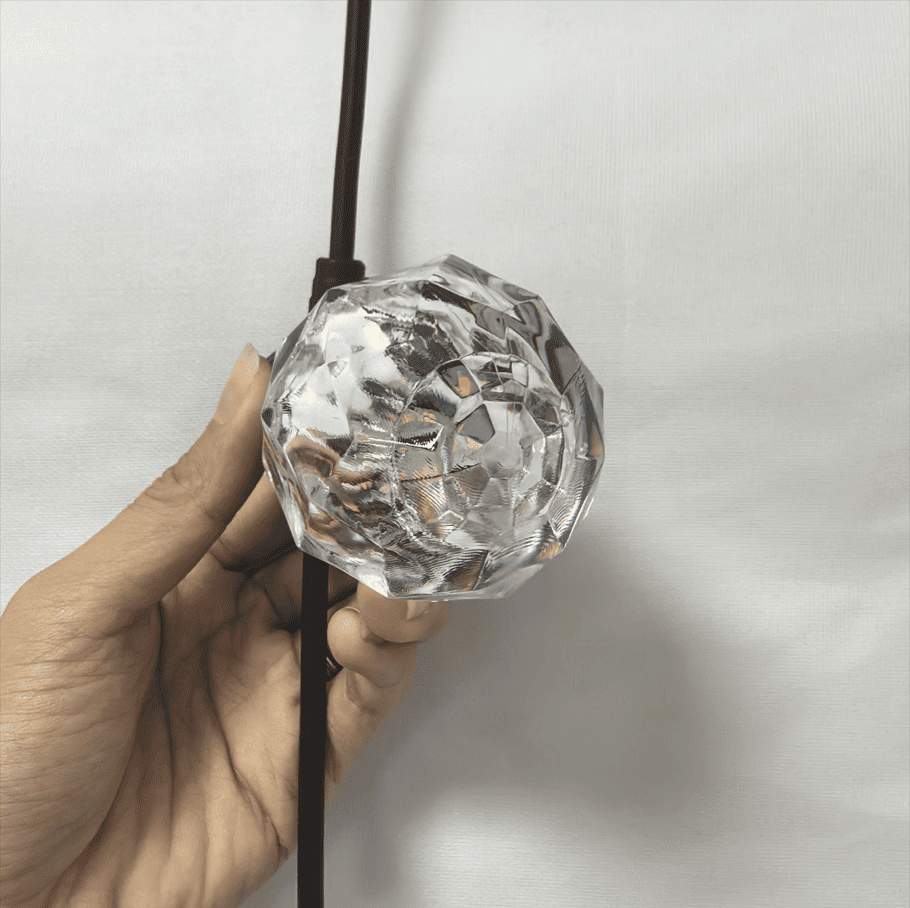 IP67 Waterproof Landscape LED String Light Plastic Bulb Handheld View IP67 waterproof landscape LED string light plastic bulb hand holding close-up showing PET plastic bulb detail before lighting