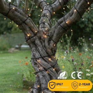 Home Warm white tree wrap string lights installed around a garden tree for outdoor decorative lighting projects