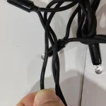LED string light cable connection close-up with black outdoor cable