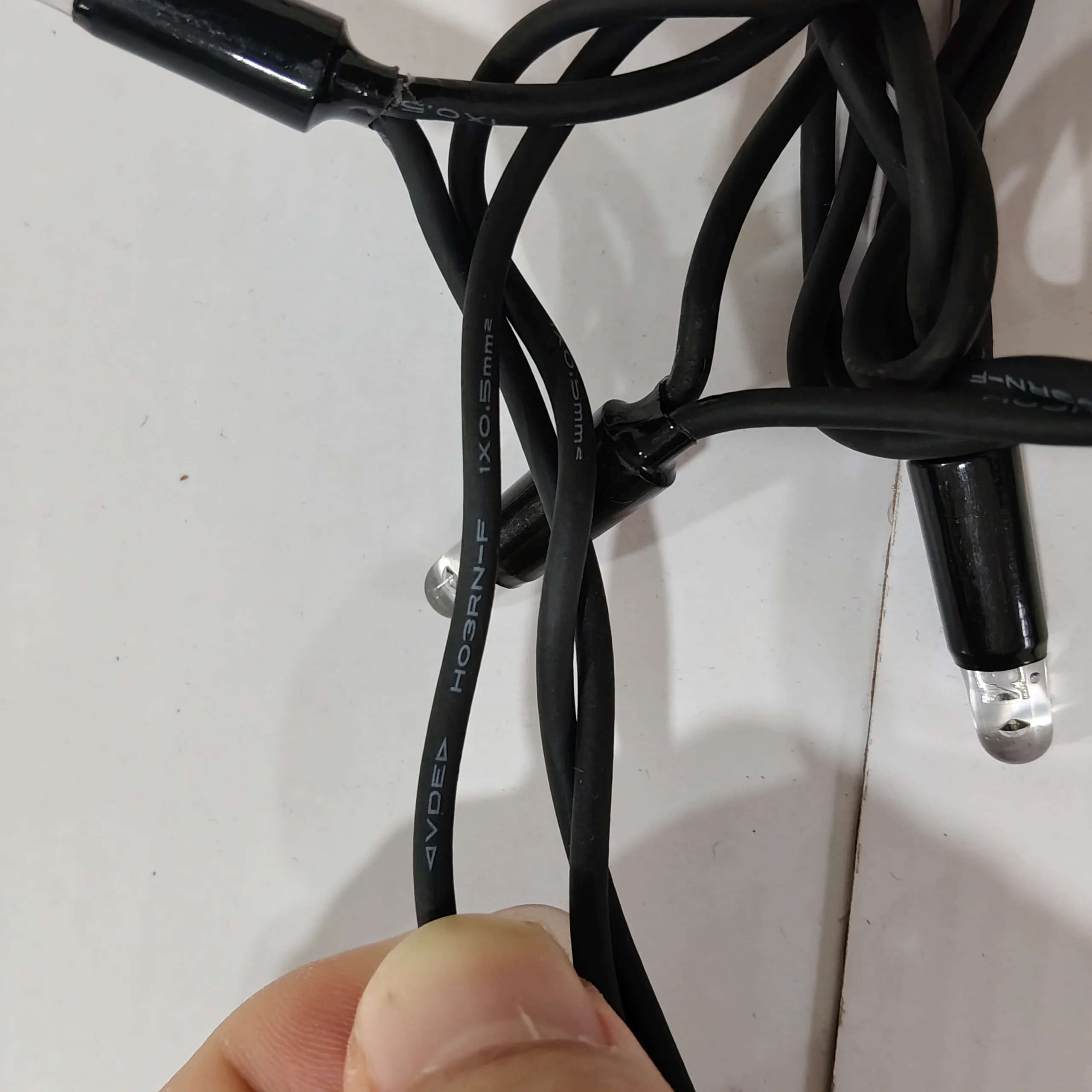 LED String Light Cable Connection Close-Up LED string light cable connection close-up with black outdoor cable